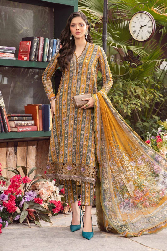 A woman wearing a traditional embroidered lawn dress with a heavy embroidered neckline and matching dupatta in a garden setting.